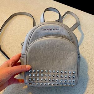 Michael Kors light gray, leather backpack purse with silver square grommets